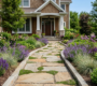Elegant natural bluestone flagstone garden path with creeping thyme and purple perennial borders in a Clarence NY front yard landscape design.